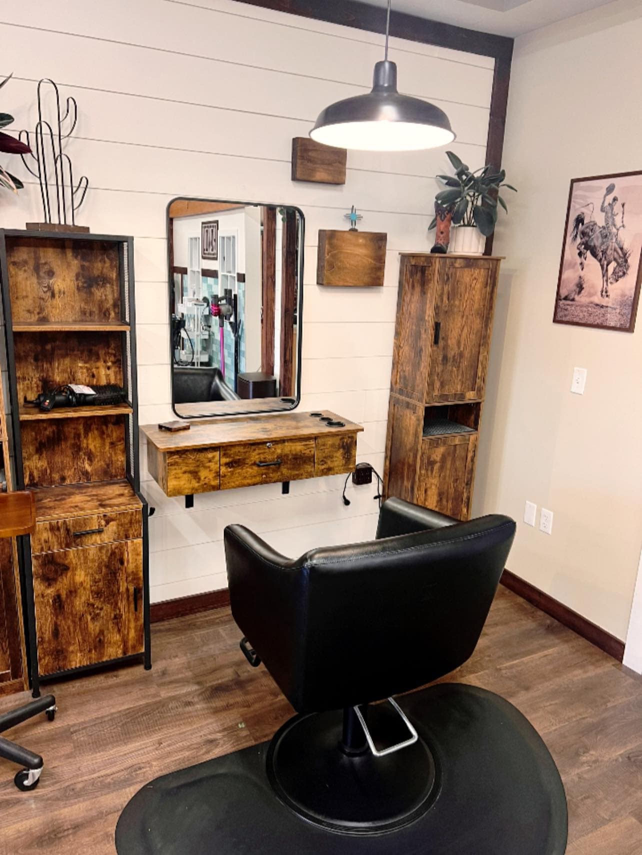 High-contrast longhorn skull mounted above the natural edge reception desk at Head West Salon